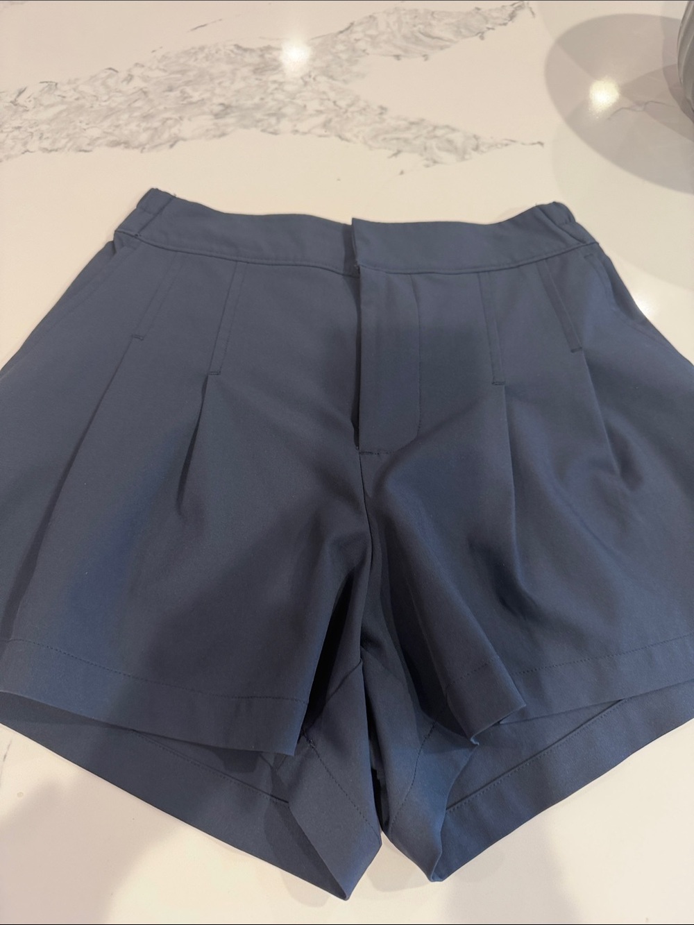 Women's Navy Pleated Shorts with white piping down the side, pockets size xs